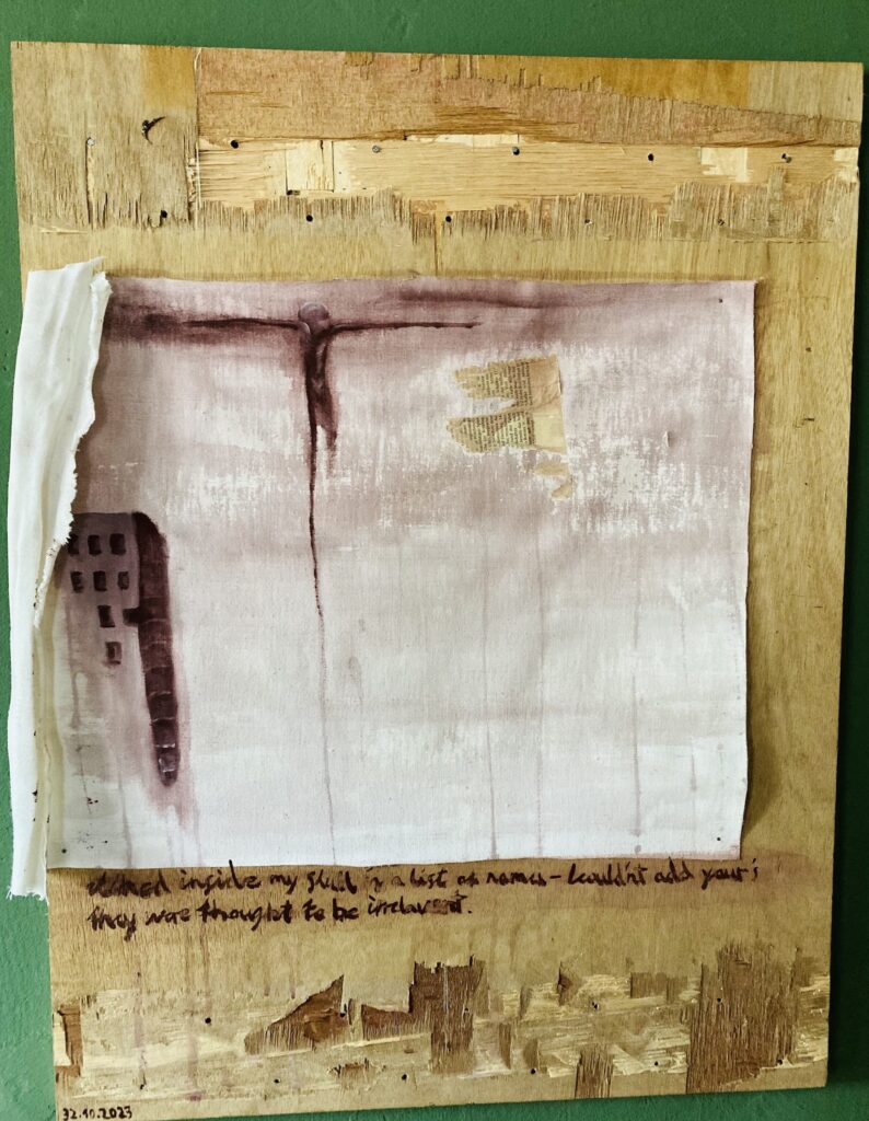 On an old wooden board, which has scratches on the top and the bottom sections, there is a sqaured piece of white cloth. To the left side of it, there is a building painted in different shades of pink, its shadow in a shade of dark red. The background of the painting is in the same two shades of pink and dark red. In the top section of the paining, close to the centre, is a figure, which appears to be floating. It is vertical, with arms outstretched to its sides, as if it is flying, one of the legs and one of the arms are abnormally prolonged till the borders of the piece of cloth. On the left side, the endpiece of the cloth is folded on the painting, covering a small section of the building and the prolonged arm.
UNderneath the piece of cloth there is a sentence, written in the same shade of dark red. It reads: What inside my skull is a list of names, wouldn't add yours, they were thought to be irrelavent.