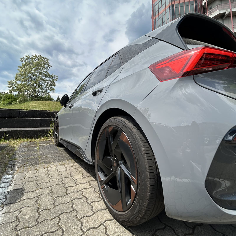 Grey Car, Tires, Wheel Rims, Sky, Tree, Red Building