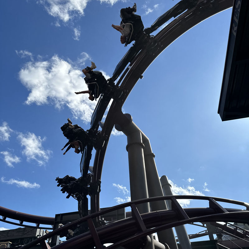 roller coaster people sky looping clouds